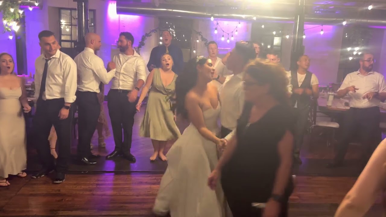 Wedding guests sharing the dance floor at a reception